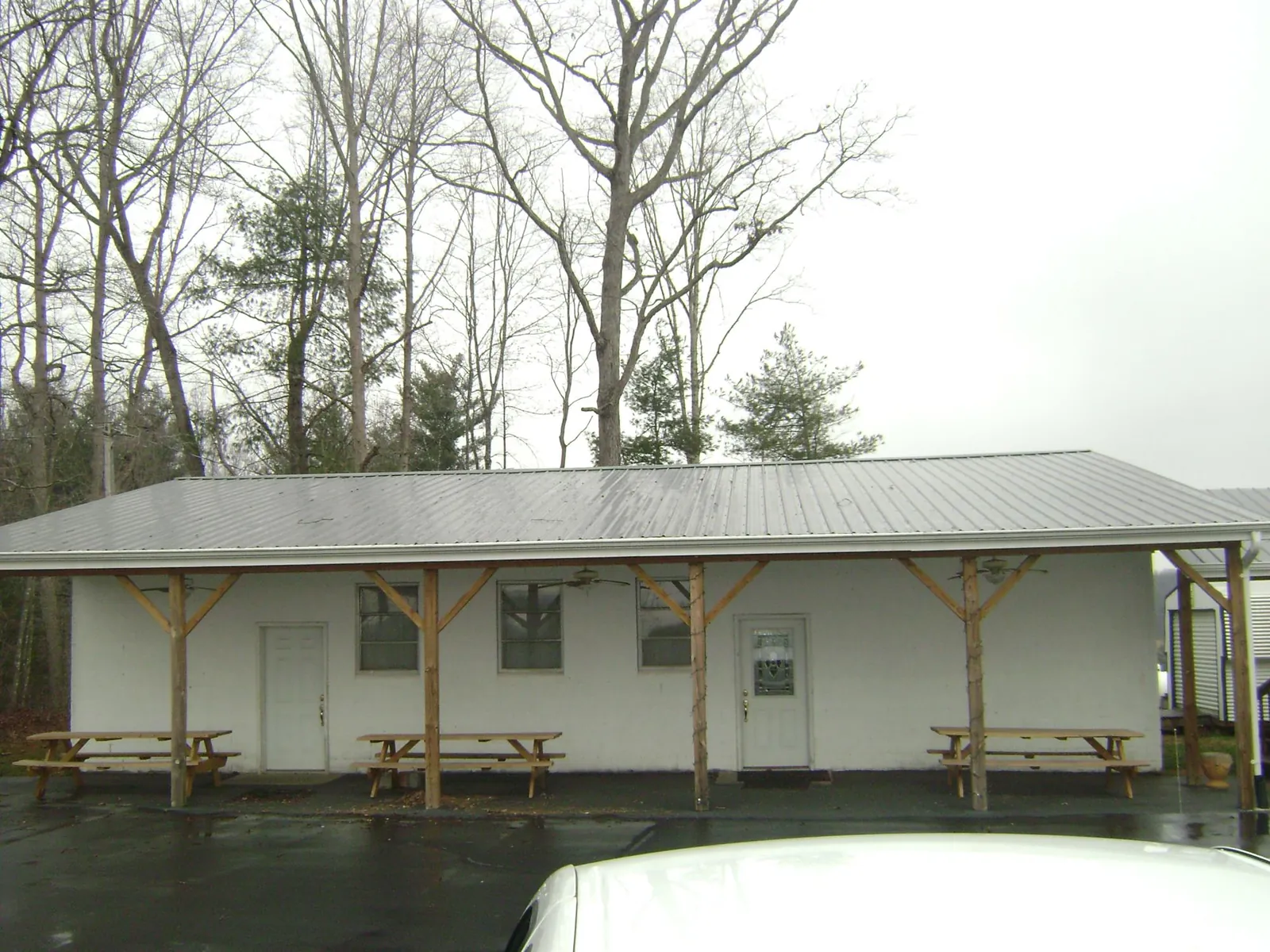 Gray metal roof over a block building with a timber post porch in Winfred